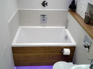 The Calyx soaking tub set in a narrow bathroom