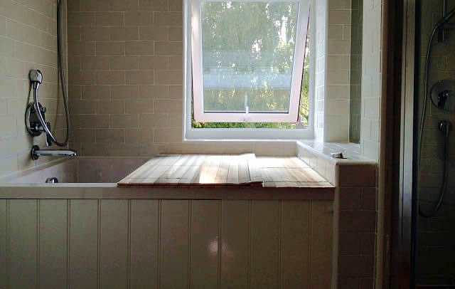 The Calyx deep soaking tub set into a wooden surround.