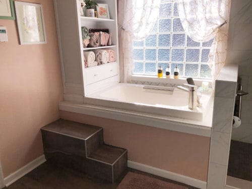 A side view of the deep soaking tub, showing the accompanying step, fitted by the installer.