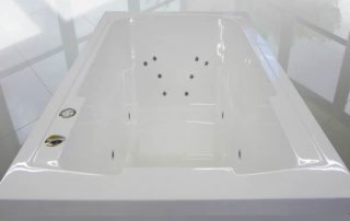 Interior of a hydrotherapy bath showing the placement of jets for the back and legs.