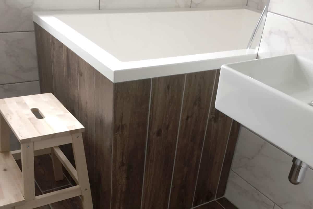 The Calyx 1440 Japanese soaking tub installed with wooden side panels, UK