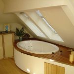In this bathroom design, the bath is inset into an extended raised deck with storage.