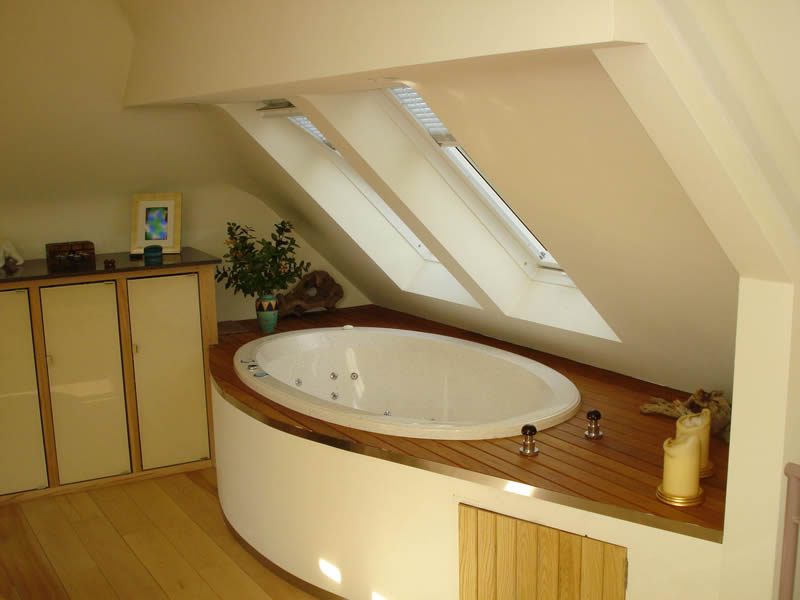 In this bathroom design, the bath is inset into an extended raised deck with storage.