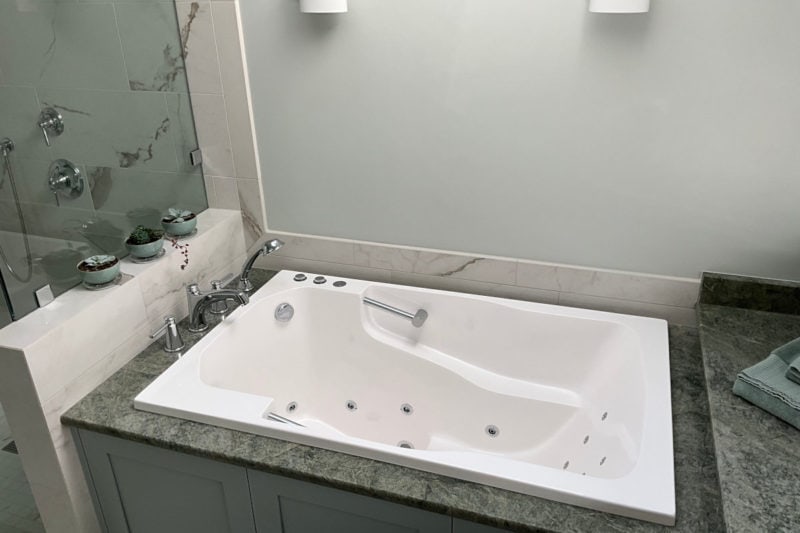 Soaking tub set into an alcove in a private bathroom in Washington, USA