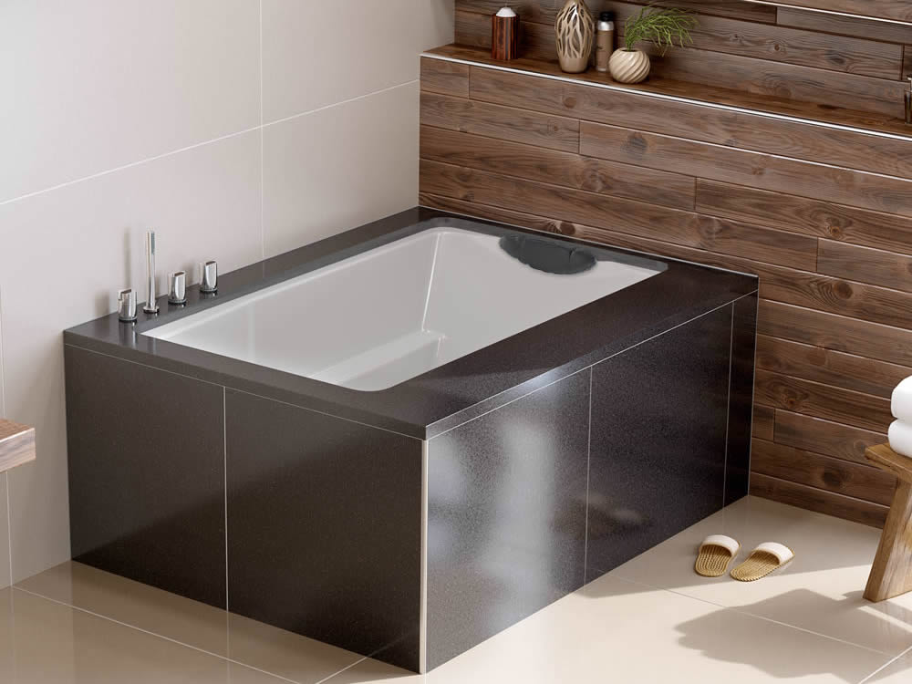 The Yasahiro deep soaking tub, used as a coner bath, undermountedbeneath a tiled surround